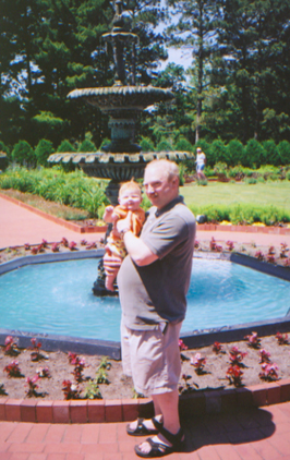 Lee holding Marosa in front of a fountain