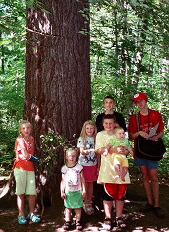 the kids in front of a big tree