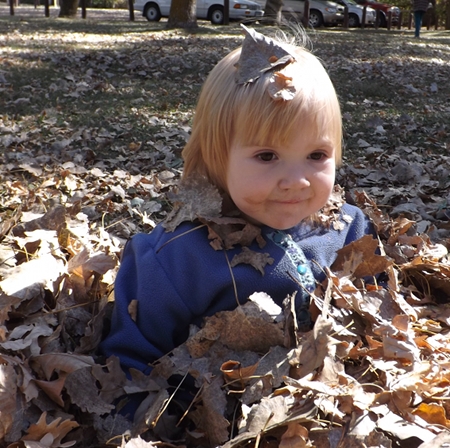 Ella in the leaves