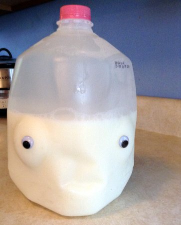 a milk carton with googly eyes