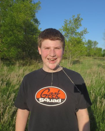 Corbin with 3 grass reeds in his mouth