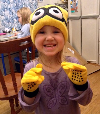 Ella in Minion hat and gloves