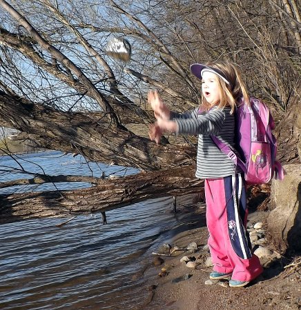 the girls throwing rocks in the lake