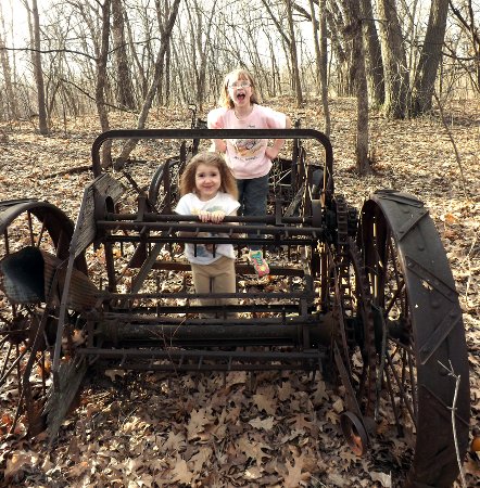 Anna and Ella in the shell of an old car