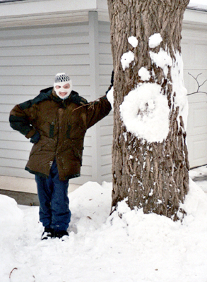 A tree with snow facial features and Alex