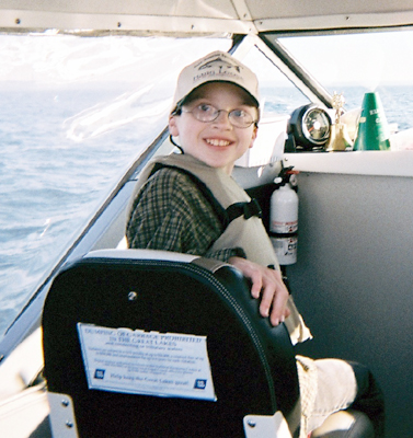 Caleb sitting in the boat