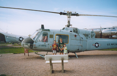 boys next to helicopter