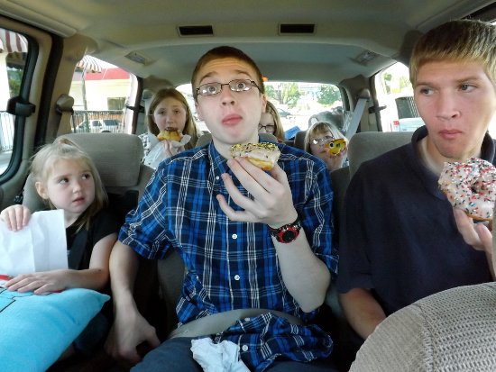 the kids eating their doughnuts in the van