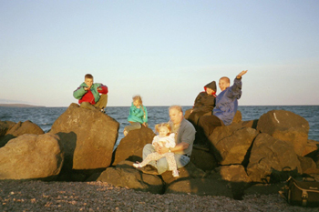 kids on rocks at sunset