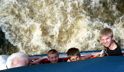 the boys and grandpa looking up, with the churning waters below