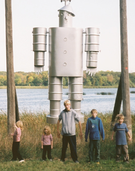 The kids in front of a large tin man