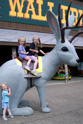 the girls ride a giant rabbit