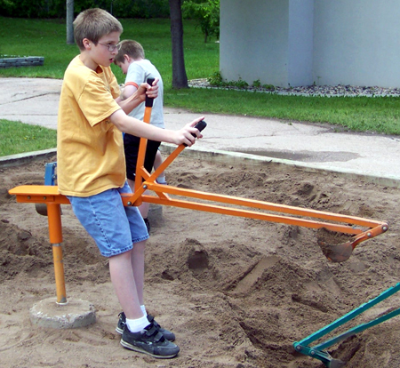Caleb digging with a crane shovel