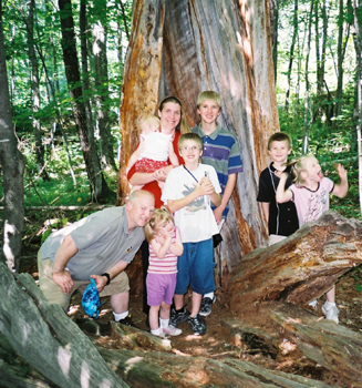 The family in front of the inside of a huge tree